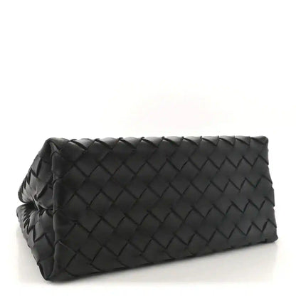 Black leather small shoulder bag with woven intrecciato pattern and folded top silhouette