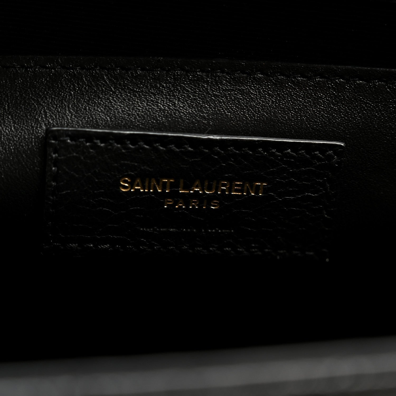 Black leather satchel with embossed “SAINT LAURENT PARIS” mark