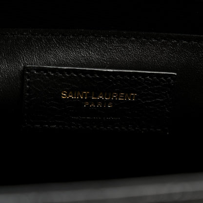 Black leather satchel with embossed “SAINT LAURENT PARIS” mark