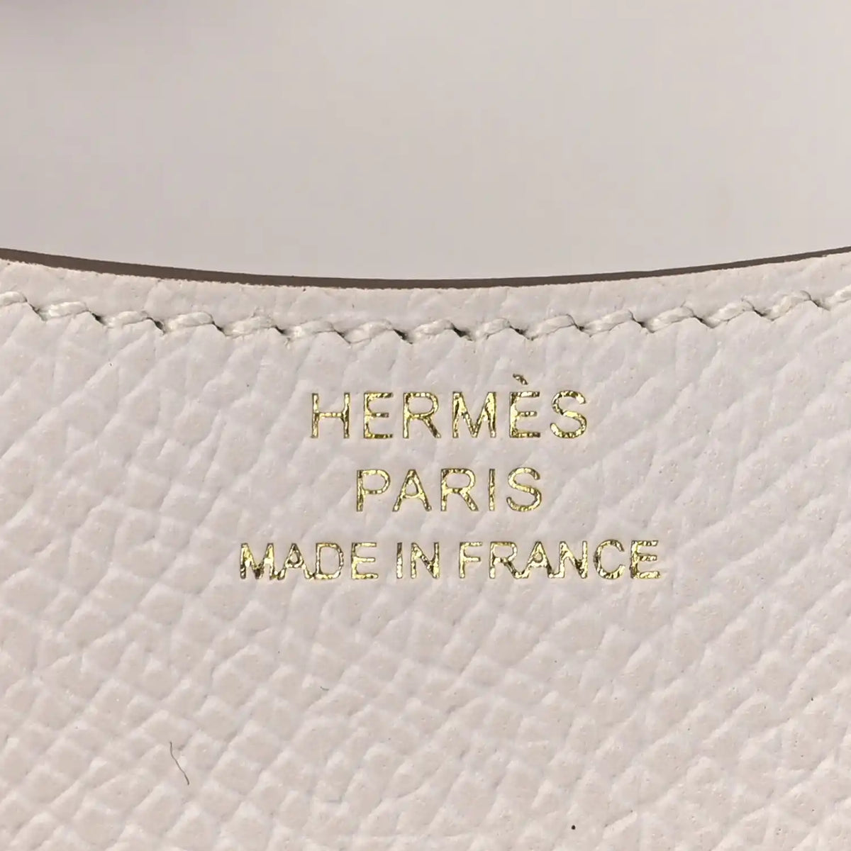 HERMÈS PARIS MADE IN FRANCE embossing on light gray leather