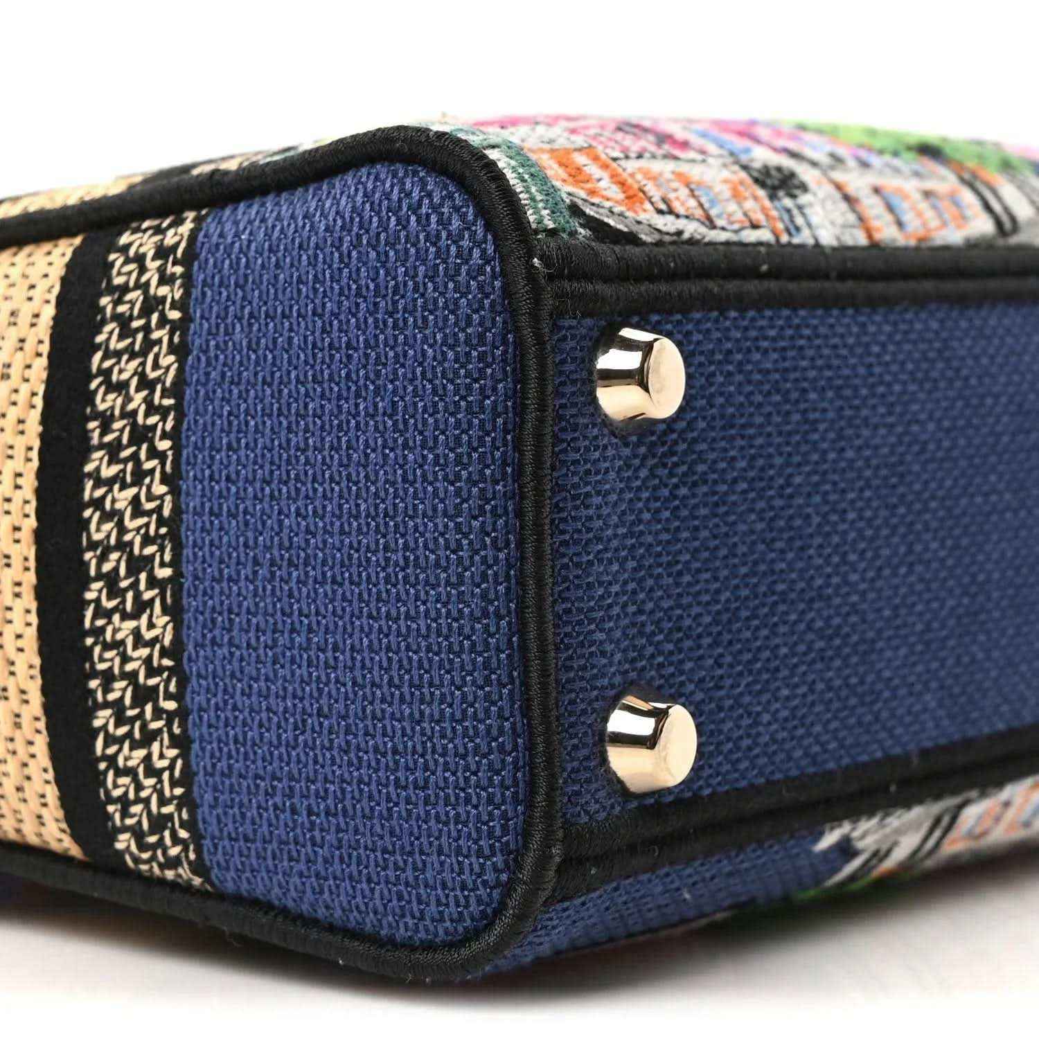 Blue handbag end panel with gold screw studs and multicolor embroidered trim