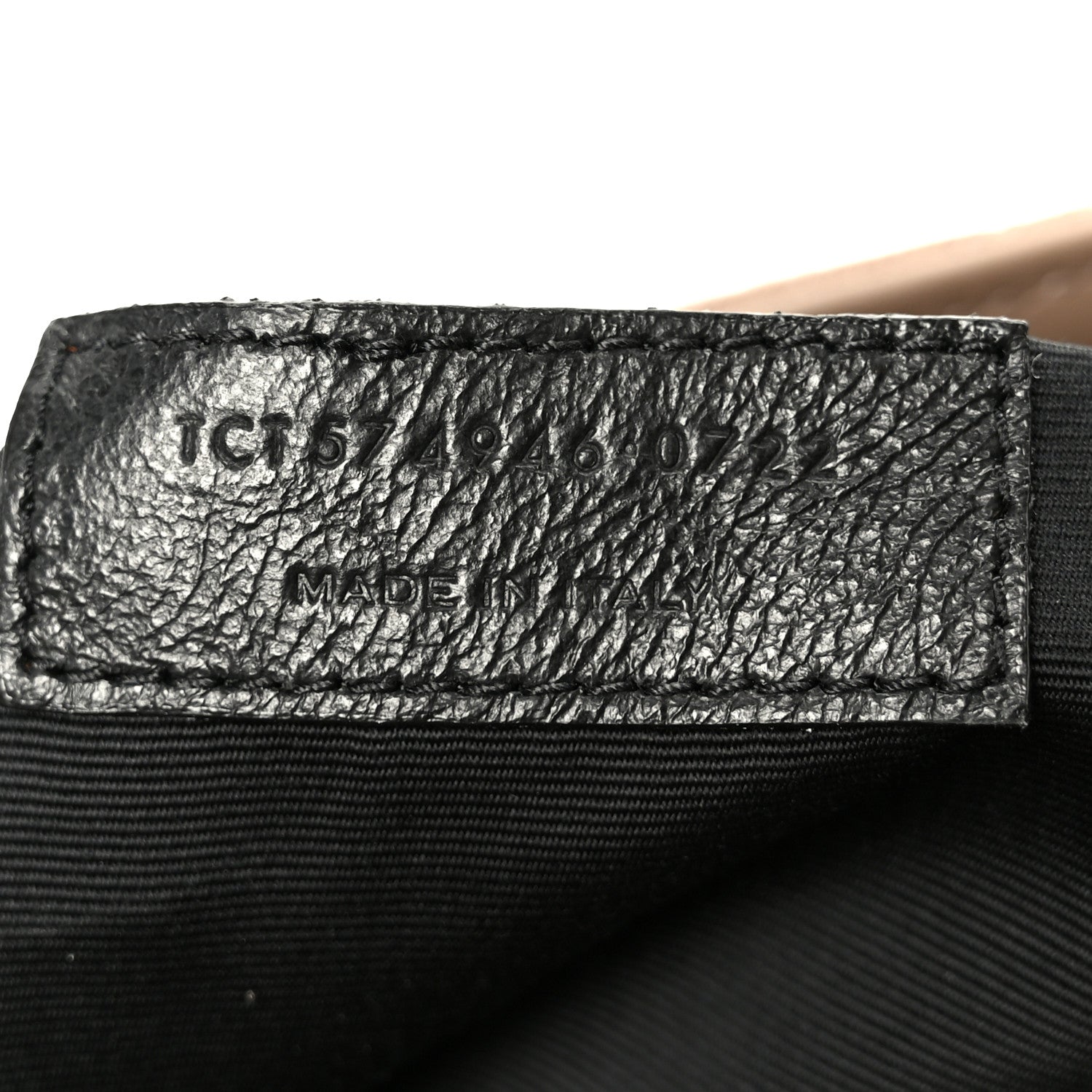 Black leather label with item code text and MADE IN stamp