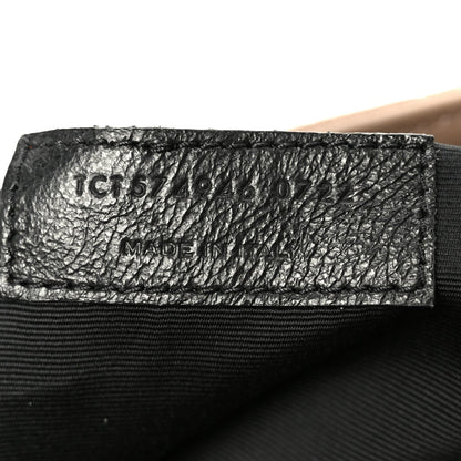 Black leather label with item code text and MADE IN stamp
