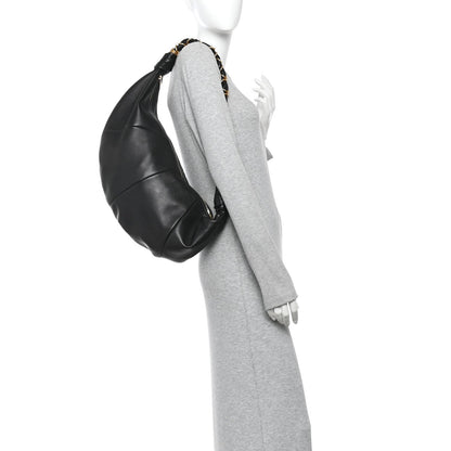 Black lambskin hobo bag with braided top handle and draped side profile