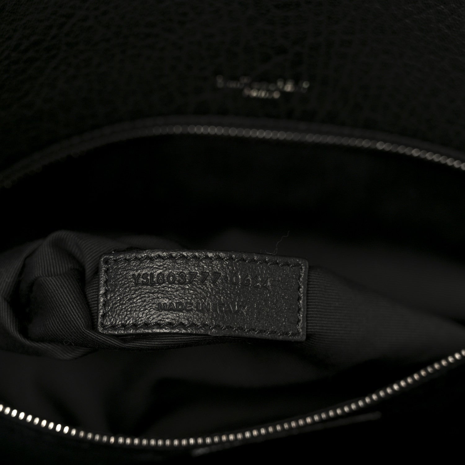 Black leather satchel interior brand label on lining