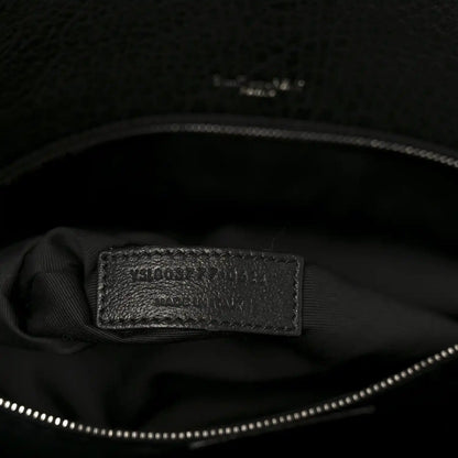 Black leather satchel interior brand label on lining