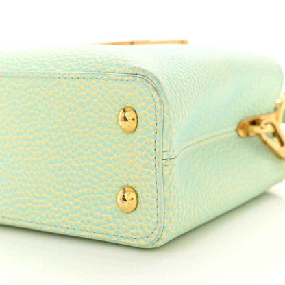 Mini Capucines handbag light green textured leather with gold corner hardware