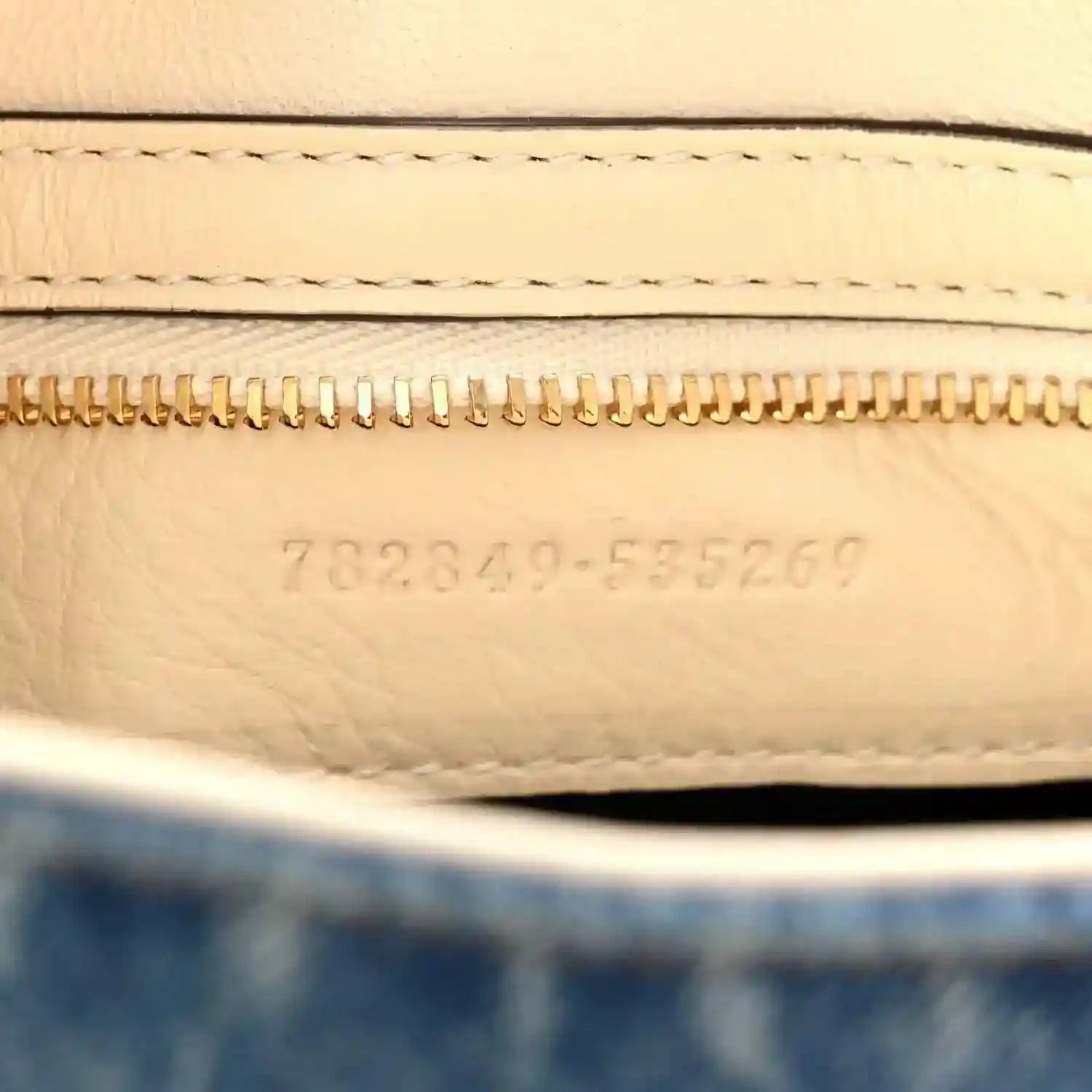 Beige leather interior with gold zipper and embossed serial code