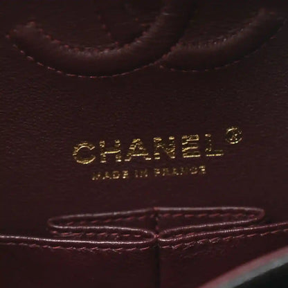 Chanel leather bag interior label with gold lettering and stitched trim