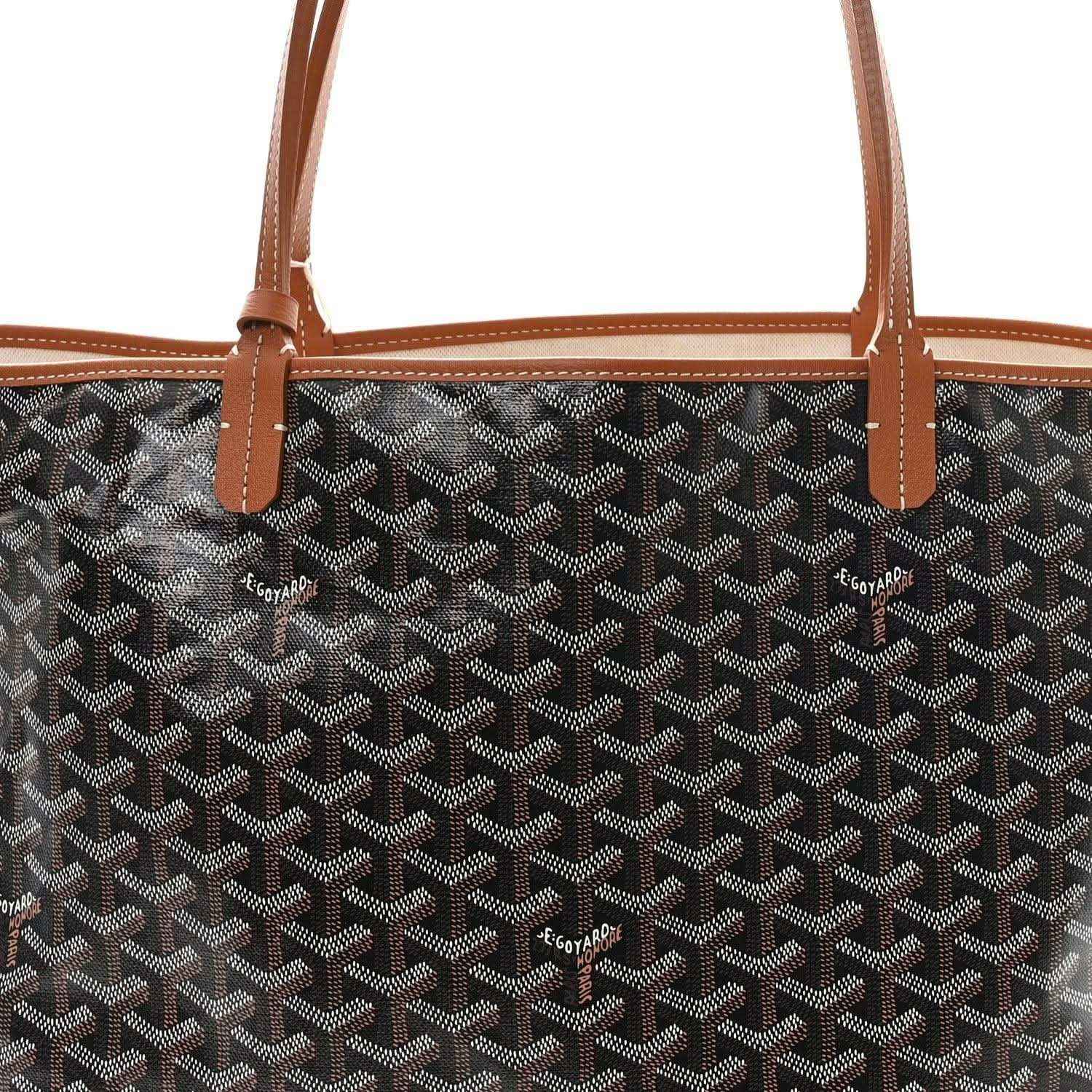 Black monogram tote front with tan leather straps and small logo tags