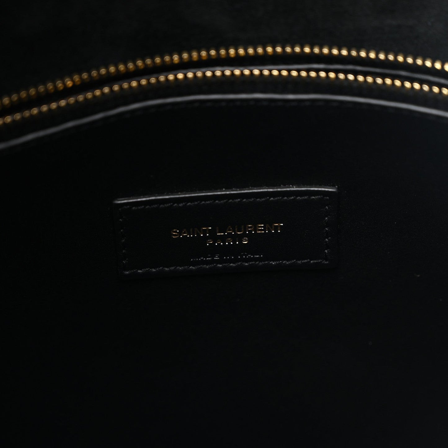 Black leather hobo bag interior logo patch with gold-toned topstitching