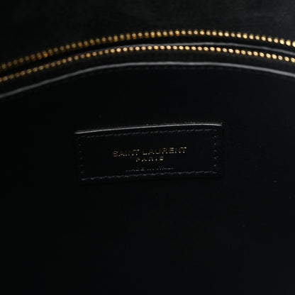 Black leather hobo bag interior logo patch with gold-toned topstitching