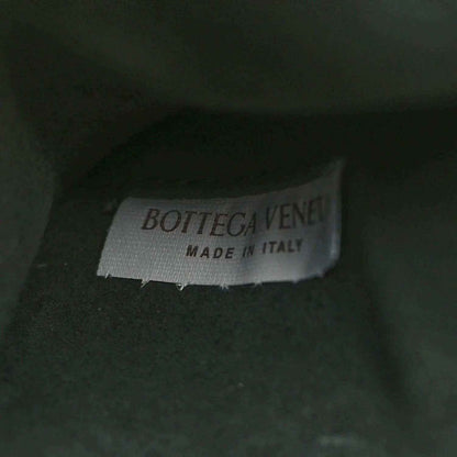 Bottega Veneta label on dark green leather, Made in Italy