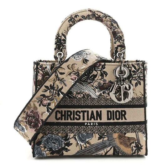 Floral embroidered canvas tote with top handles and Christian Dior logo front band.