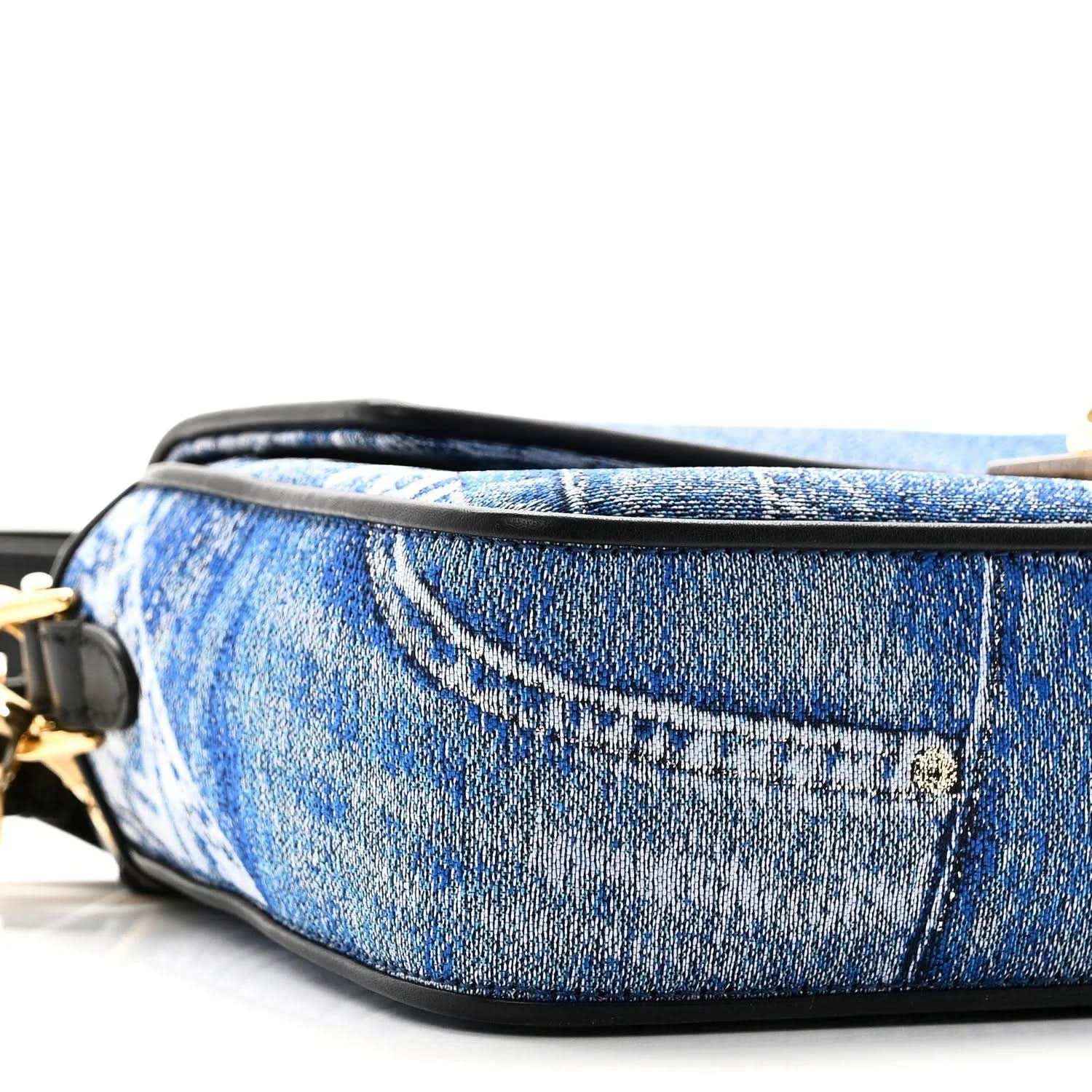 Blue denim baguette bag side with black leather trim and gold-toned hardware