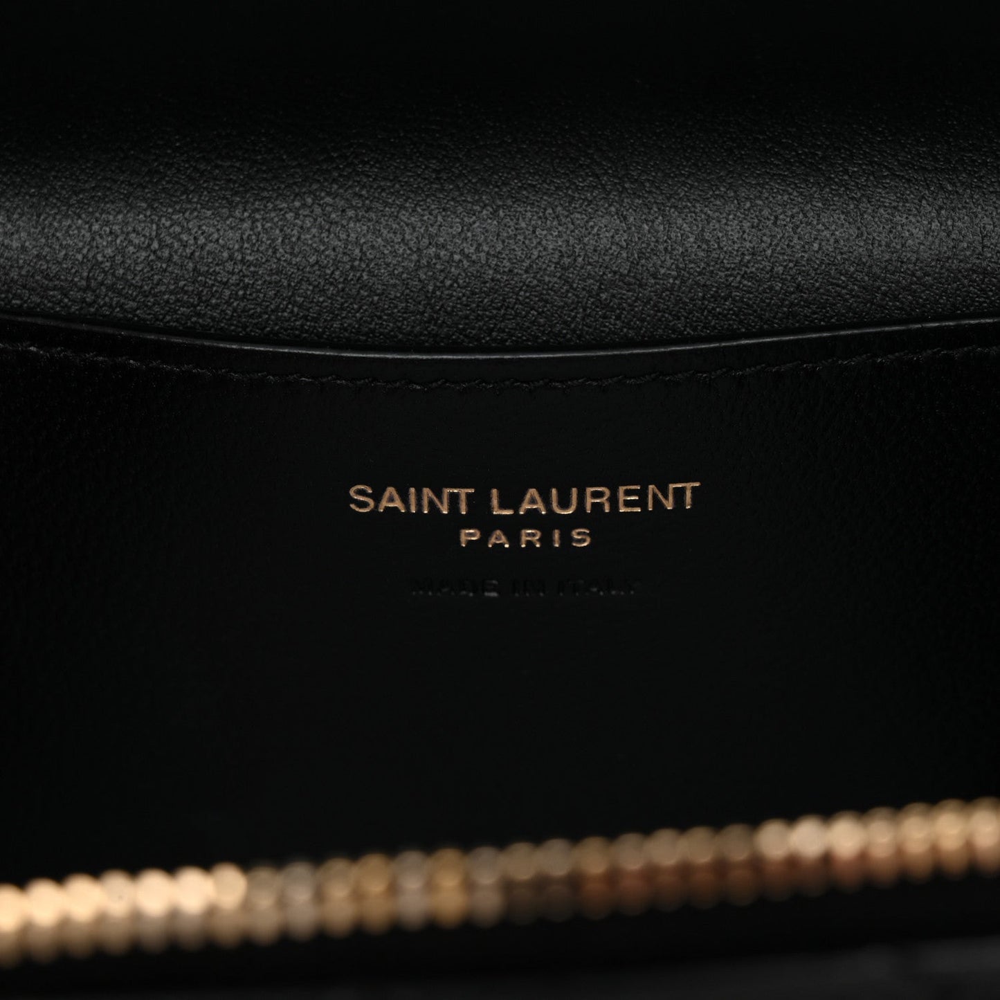 Saint Laurent Paris branding on black leather lining inside mini vanity case