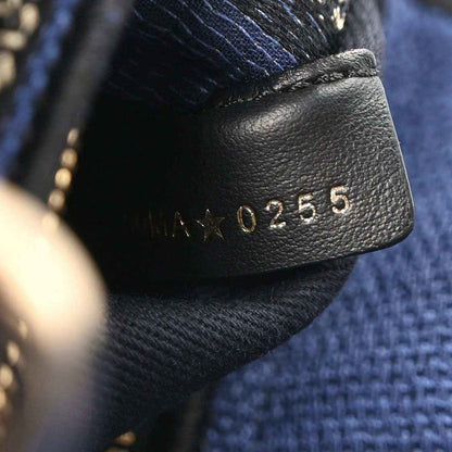 Black leather pull tab with embossed numbers 01255 on an embroidered strap