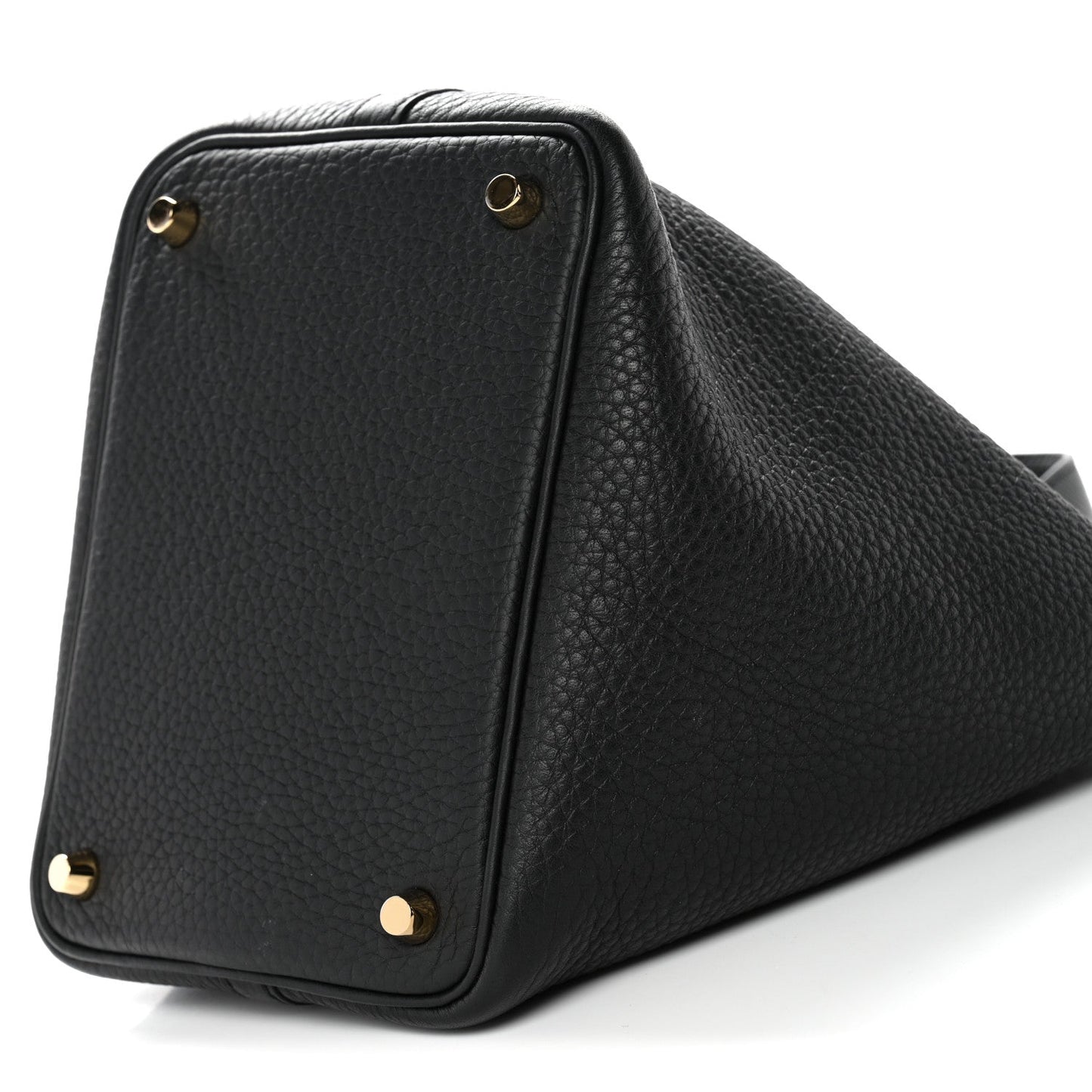 Black textured leather tote corner close-up with gold hardware and top edge