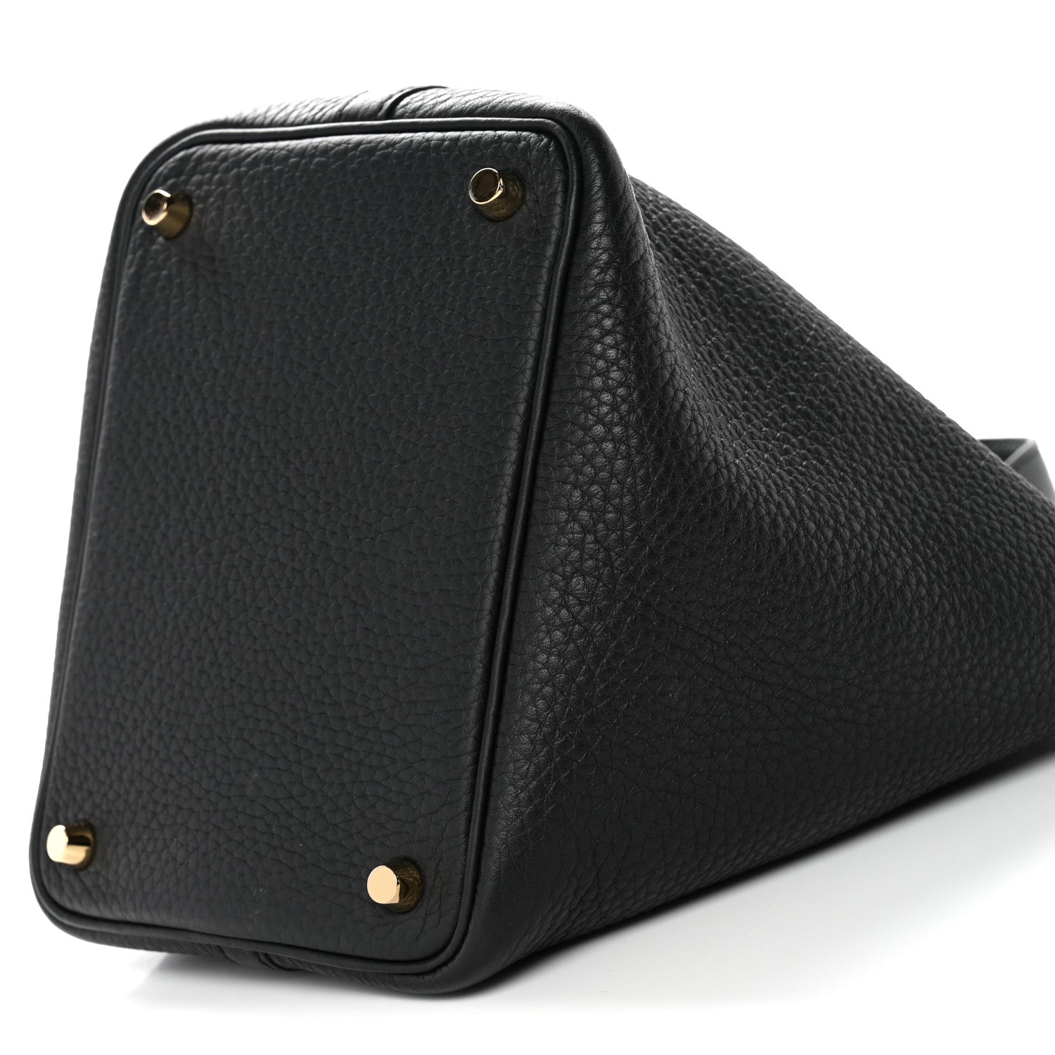 Black textured leather tote corner close-up with gold hardware and top edge