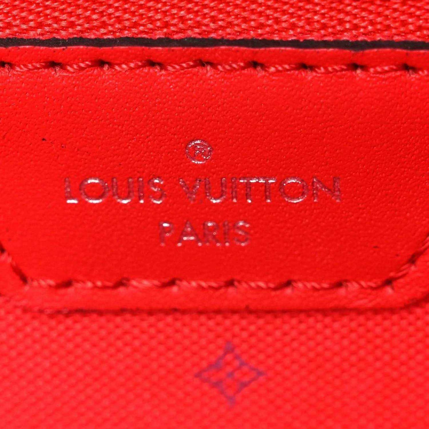 Red leather Louis Vuitton Paris label with stitched edge