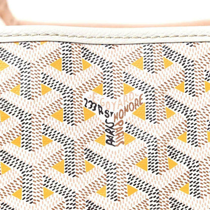 Close-up of yellow and brown star-pattern canvas with Goyardine text