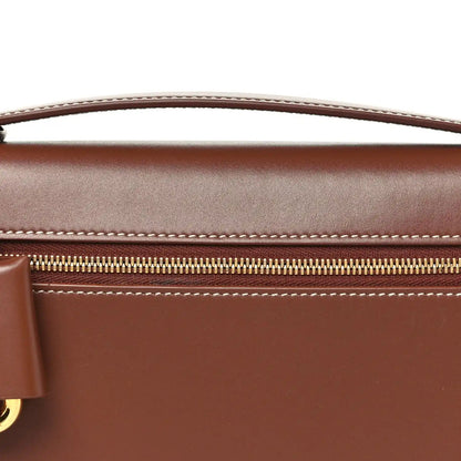 Loro Piana smooth calfskin clutch detail with gold zipper and contrast stitching