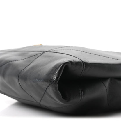 Black quilted lambskin shoulder bag with stitched panels and curved opening