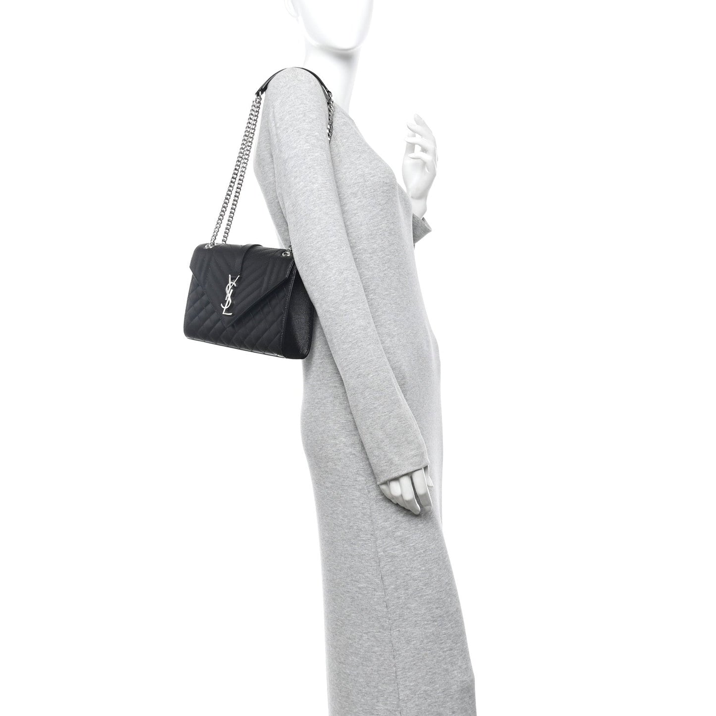 Black quilted crossbody satchel with chain strap on a mannequin