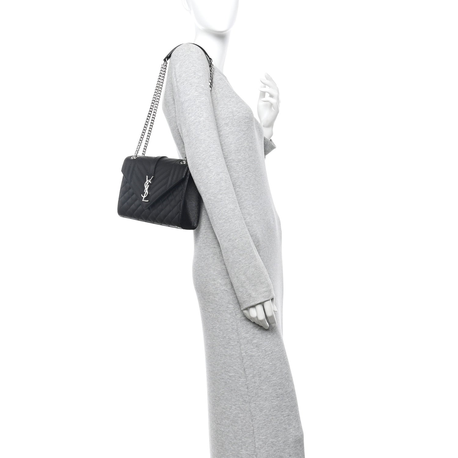 Black quilted crossbody satchel with chain strap on a mannequin
