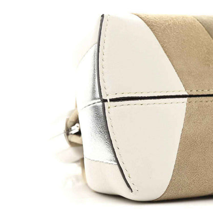 Striped nappa suede clutch side view with stitched edge seam and hardware