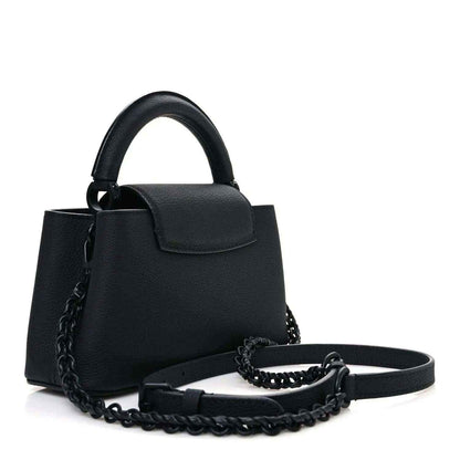 Louis Vuitton mini black leather handbag with chain strap and top handle.