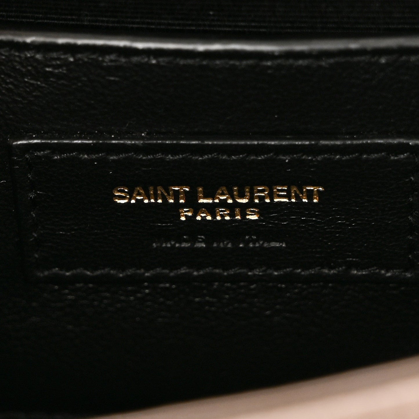 Saint Laurent Paris stamp on black leather satchel lining