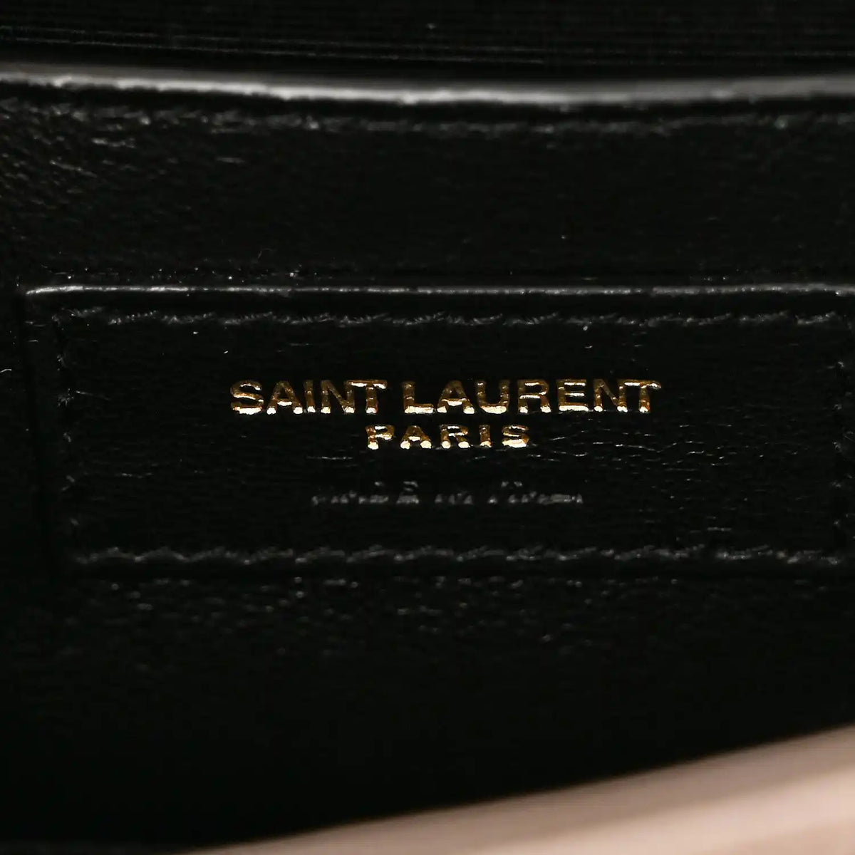 Saint Laurent Paris stamp on black leather satchel lining