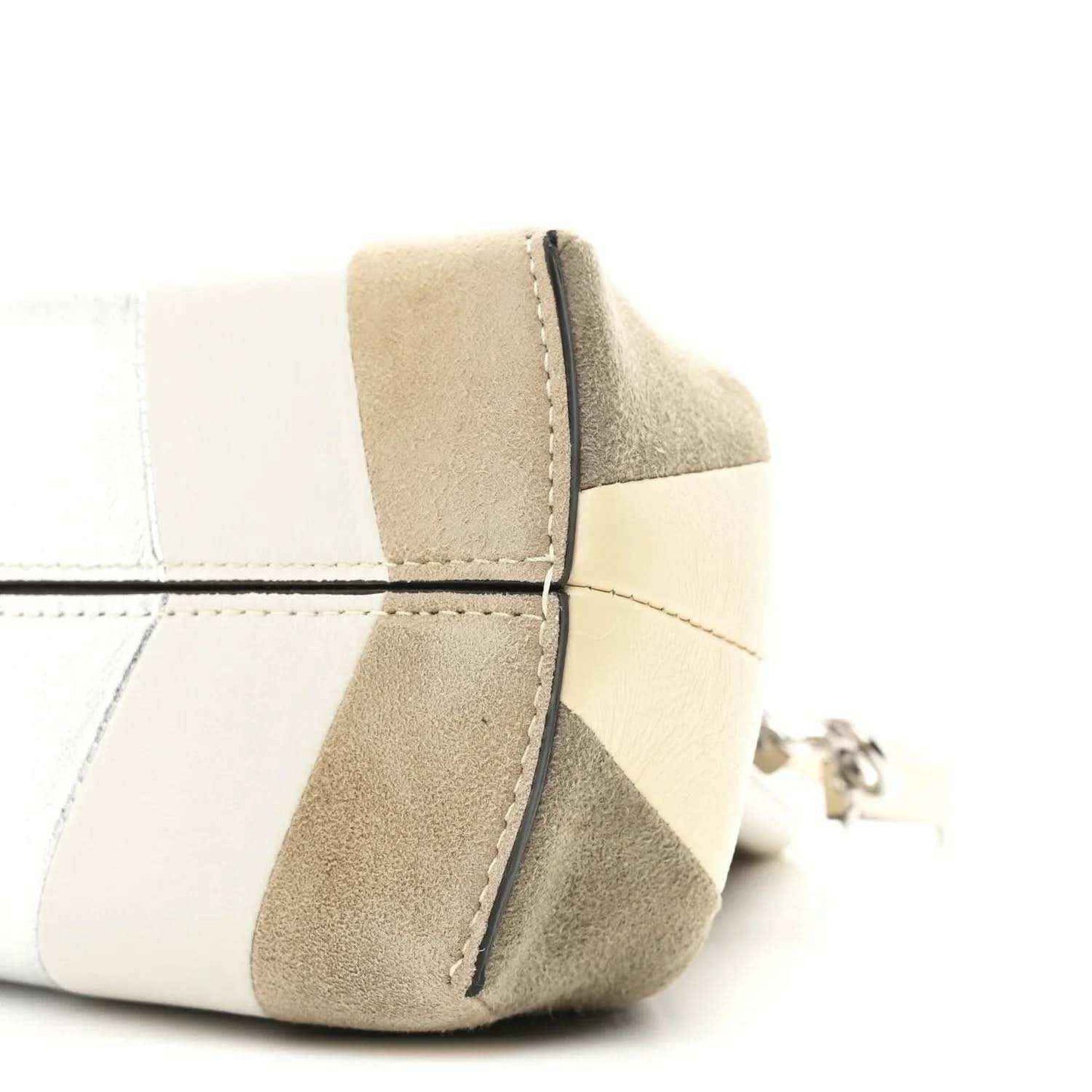 Striped nappa suede clutch corner detail with curved seam and metal ring