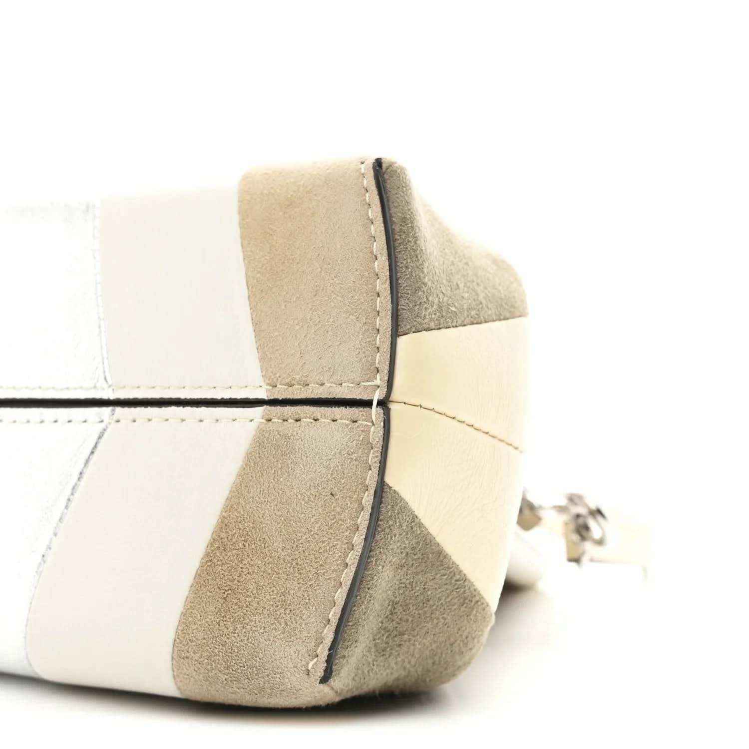Striped nappa suede clutch corner detail with curved seam and metal ring