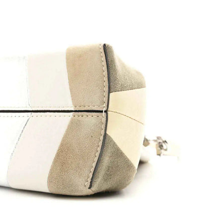 Striped nappa suede clutch corner detail with curved seam and metal ring