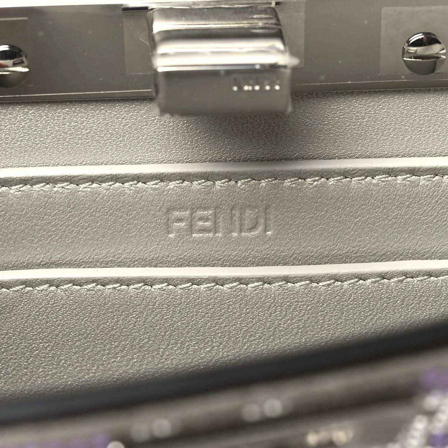 Small satchel interior close-up with embossed FENDI logo on lining