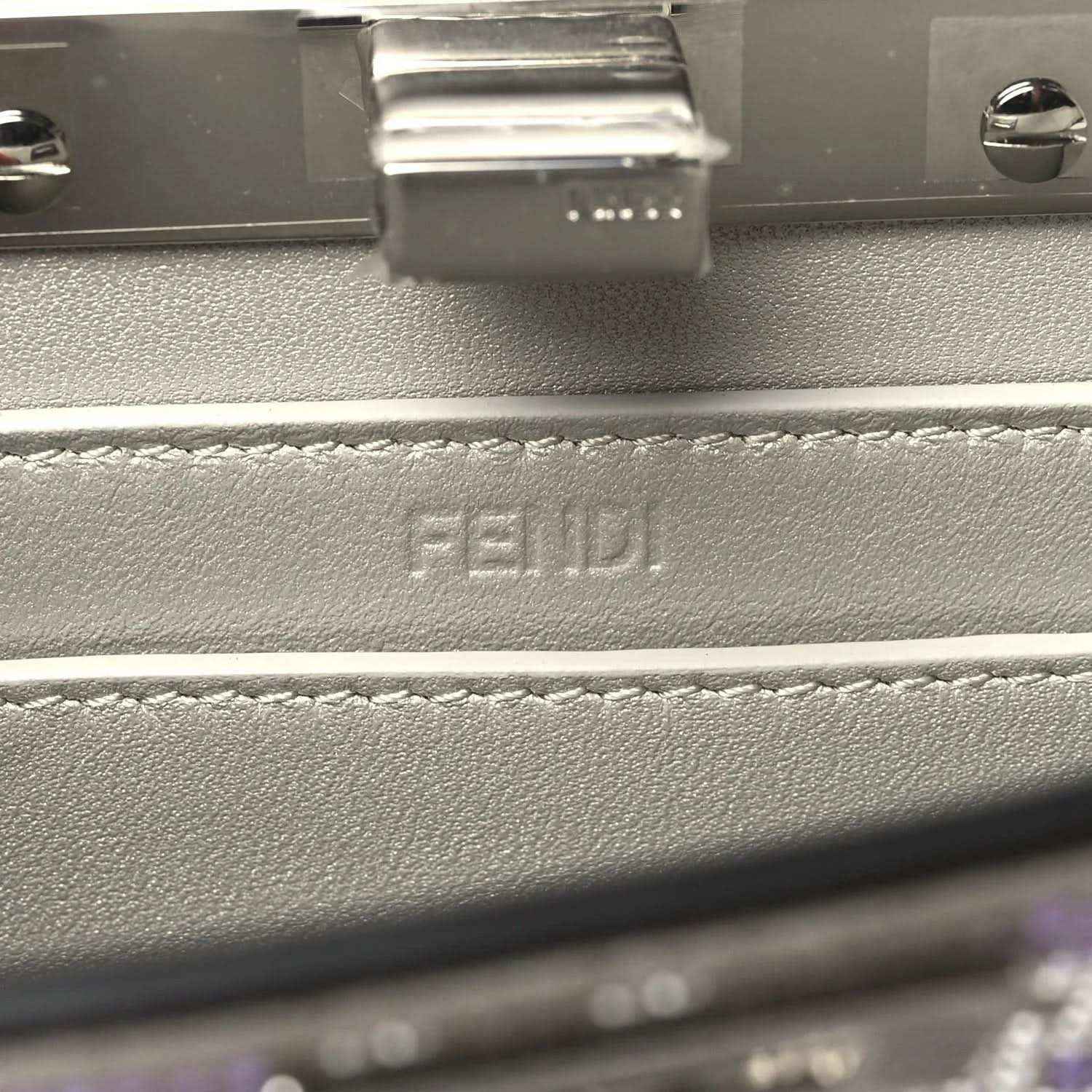 Small satchel interior close-up with embossed FENDI logo on lining