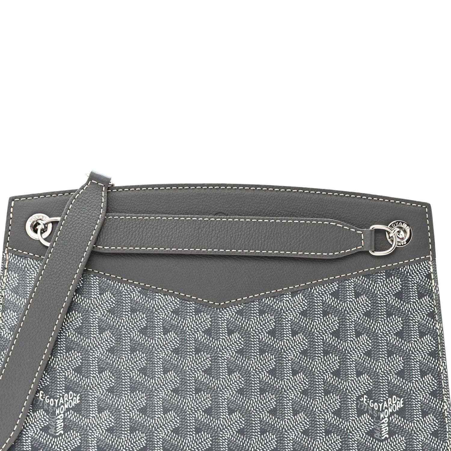 Grey shoulder bag top edge with metal hardware ring and monogram panel detail