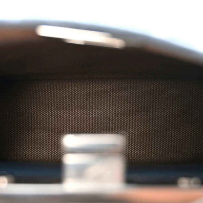 Close-up of satchel interior label area with stitched leather trim