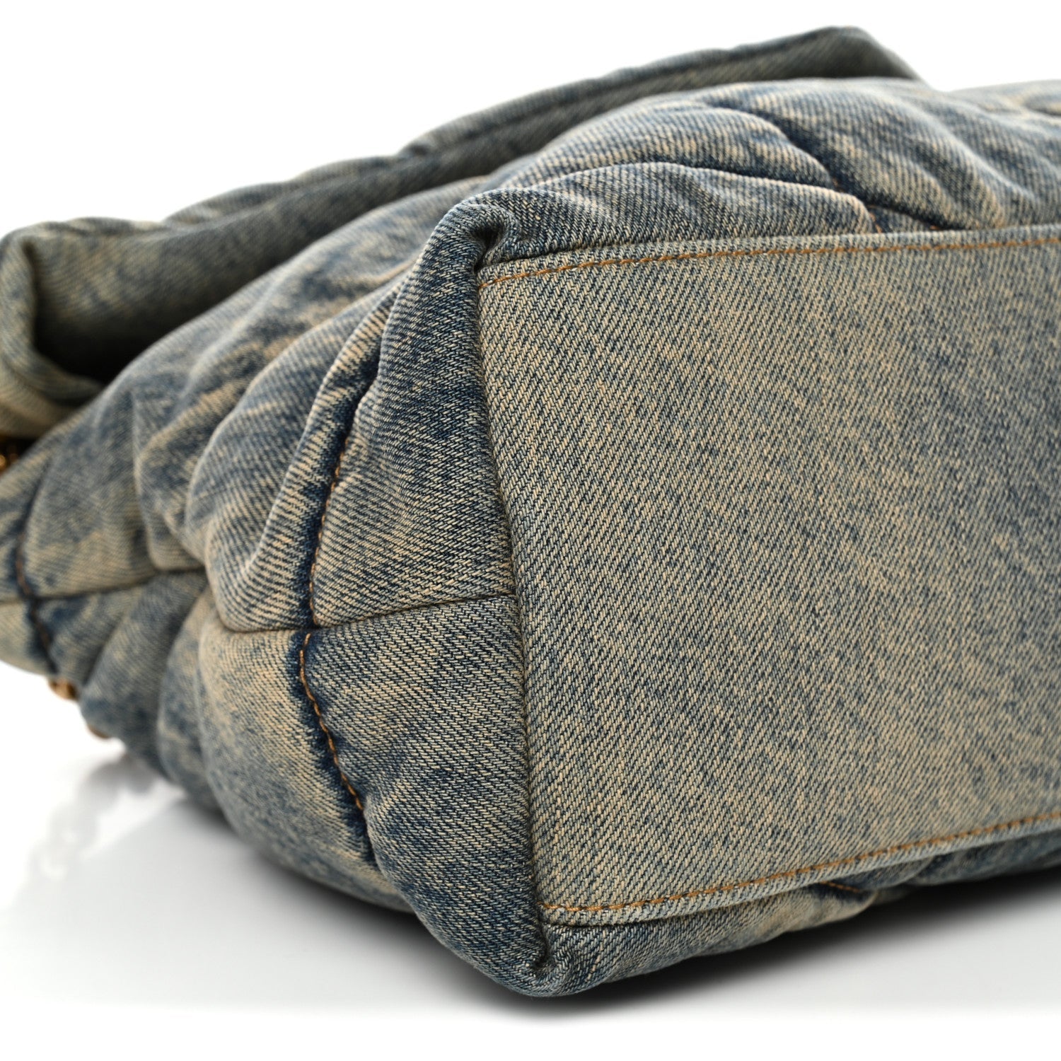 Denim puffer satchel back panel with top flap and stitching