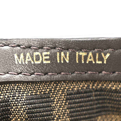 Close-up of “MADE IN ITALY” stitching on dark leather trim.