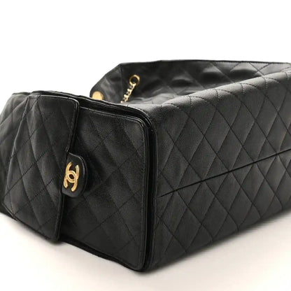 Black Chanel quilted leather handbag with gold hardware and chain strap, medium size
