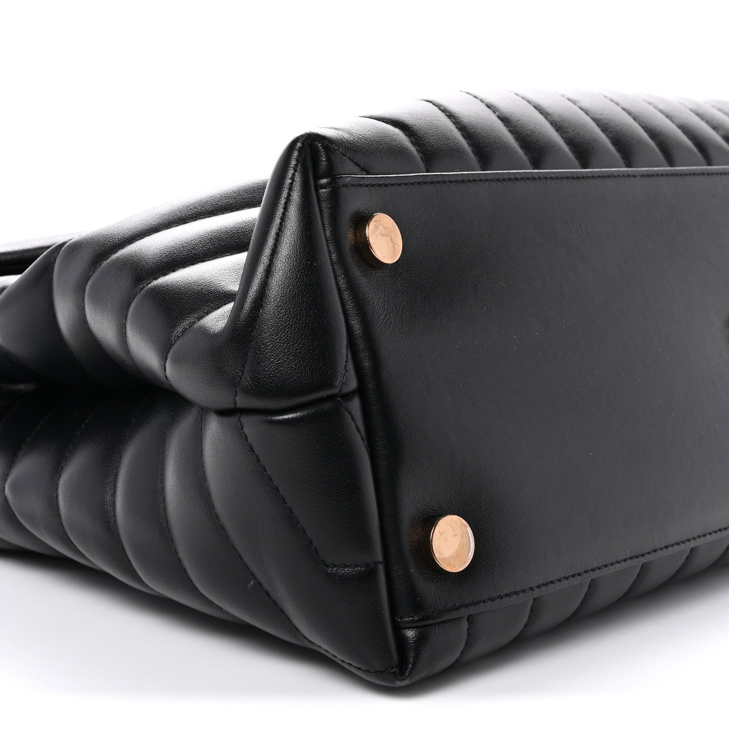 Black quilted satchel corner with gold snap buttons and curved side seam