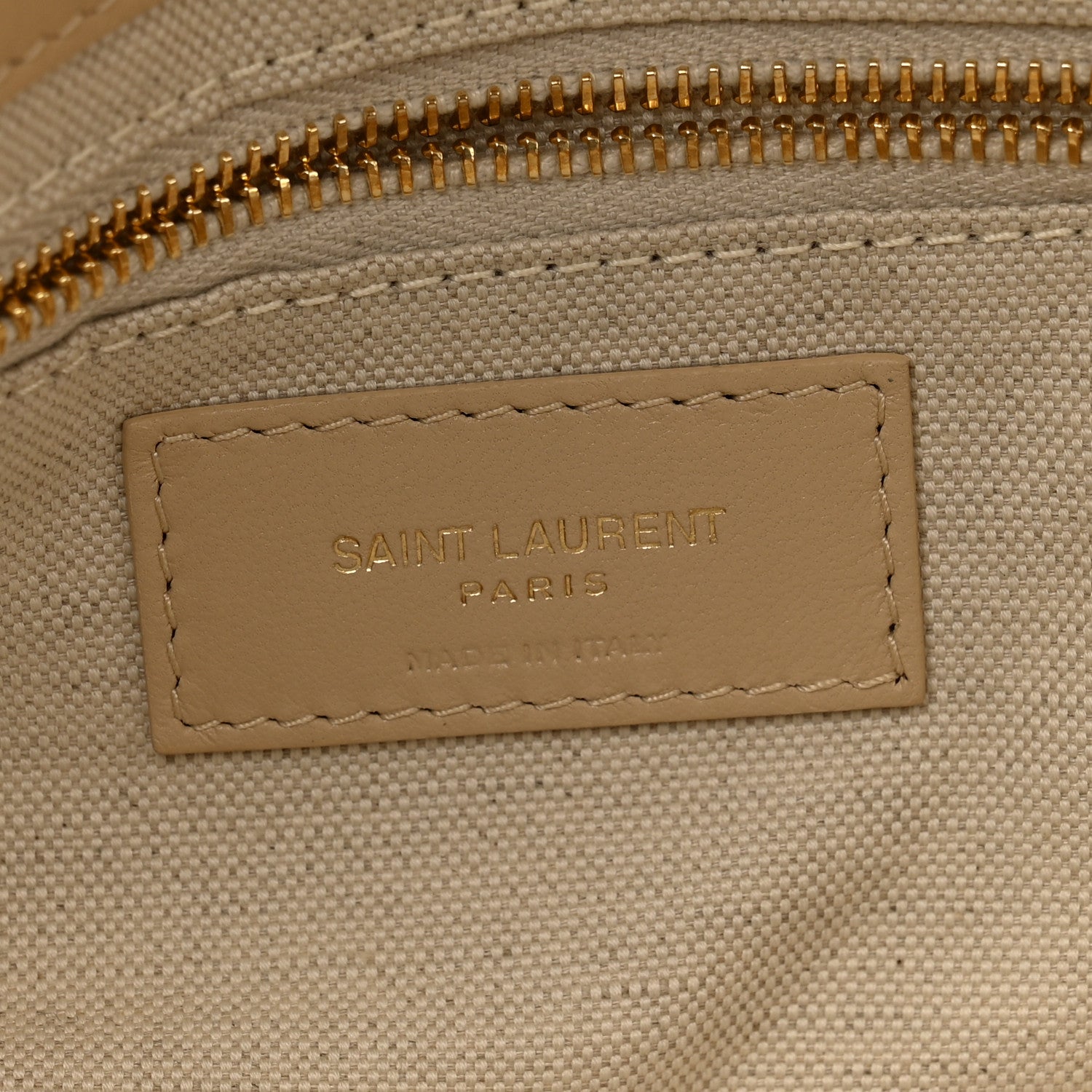 Beige interior leather label reading SAINT LAURENT PARIS with stitched border