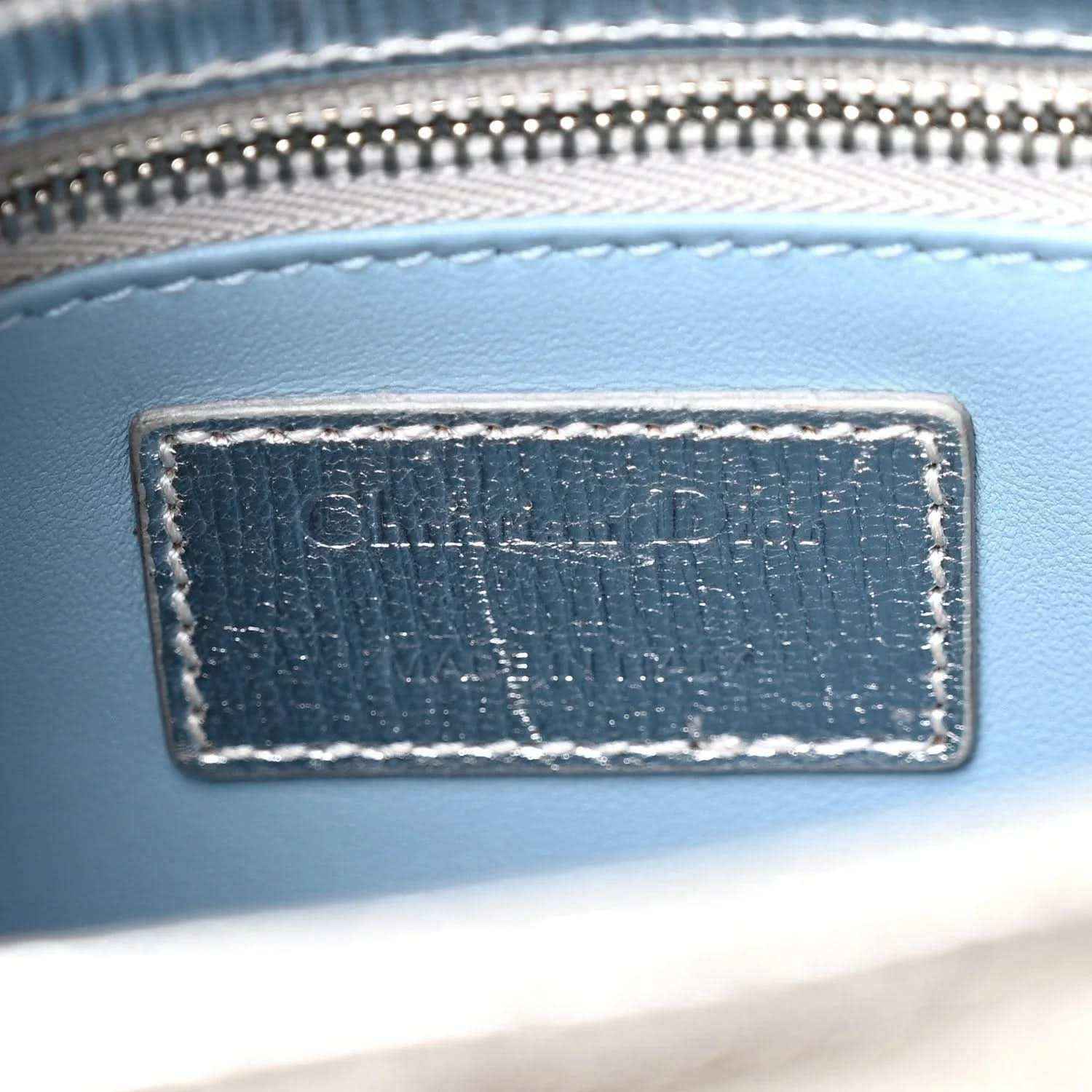 Christian Dior label patch on blue leather bag