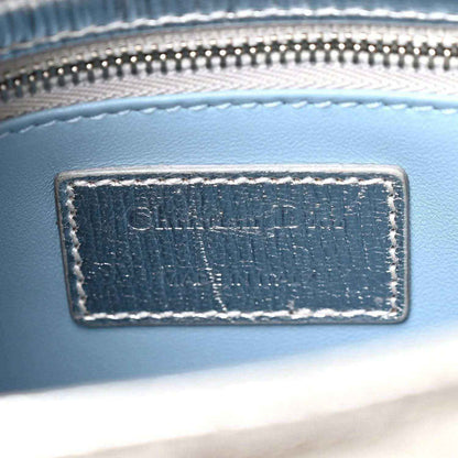 Christian Dior label patch on blue leather bag