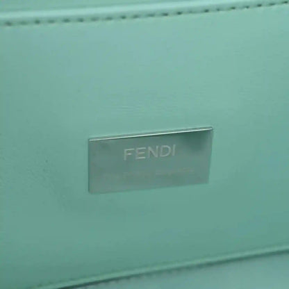 Blue baguette bag close-up of metallic FENDI logo plate