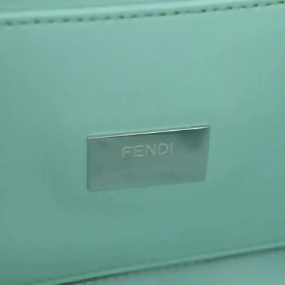 Blue baguette bag close-up of metallic FENDI logo plate