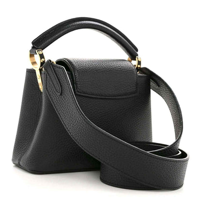 Black textured leather mini handbag with curved shoulder strap and gold-tone clasp hardware